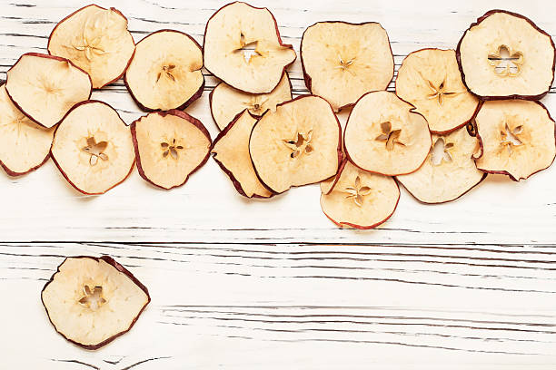 istock round dried apple chips on wooden background 2218650646