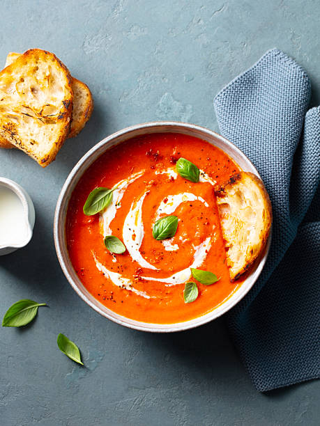 istock Roasted tomato soup with cream in a white bowl on grey background. Top view. 2218652361