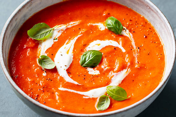 istock Tomato soup with cream in a white bowl on grey background. Close up. 2218652675