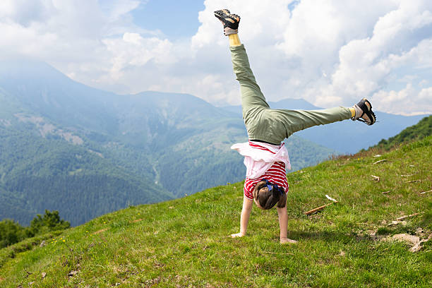 It's early summer in the high mountain pastures surrounding Bielmonte in the Zegna Oasis. The sun is shining and nature is awakening from its winter hibernation. Here is a cute little girl working out in front of the wild inhabited valley, called Valsessera, stretching between the Cervo Valley and Valsesia. Proud of her fitness, she engages in some gymnastic exercises. The majestic alpine scenery gives her a kind of inner strength, confronting her potential as a growing girl with almighty nature.