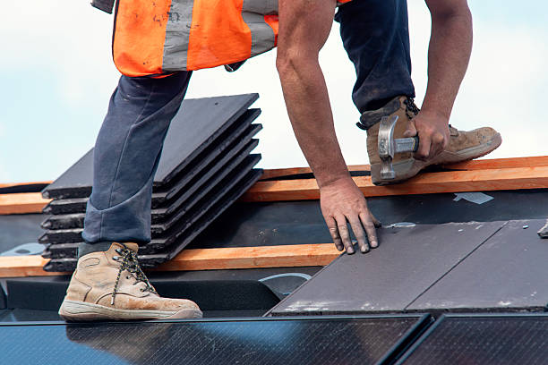 istock Construction worker roofers installing roofing tiles on residential building 2218653270