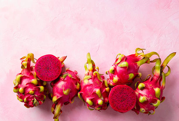 istock Asian exotic Dragon fruit, pitahaya. Pink background. Copy space. Top view. 2218654603