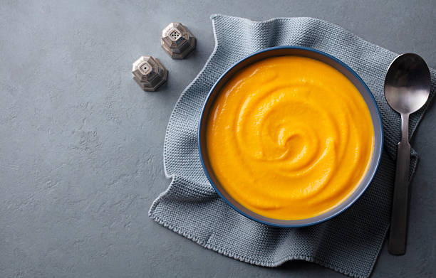 istock Pumpkin traditional soup with creamy silky texture. Grey background. Copy space. Top view. 2218654637
