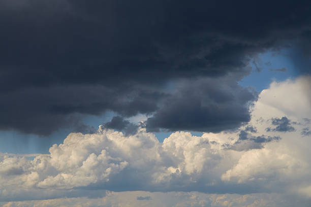 istock Thunderstorm cloud Cumulonimbus. A gloomy cloud with a dark base. Sunlight glints on the wispy edges 2218655448