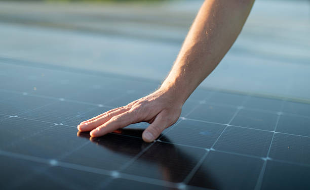 istock Solar panel, Photovoltaic system, Green Energy. Human hand touching solar panel. 2218657800