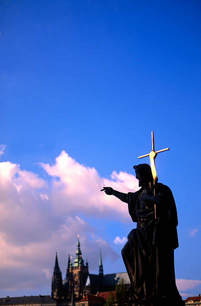 Czech Republic, Prague, statue on The Charles bridge  background St. Vitus cathedral.