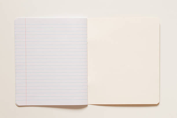 istock One notebook in a line, fastened with staples on a white background, educational background for school 2218659304
