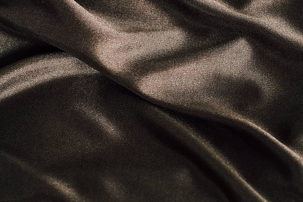 istock Rich brown satin fabric draped gracefully showcasing its smooth texture and sheen 2218659780