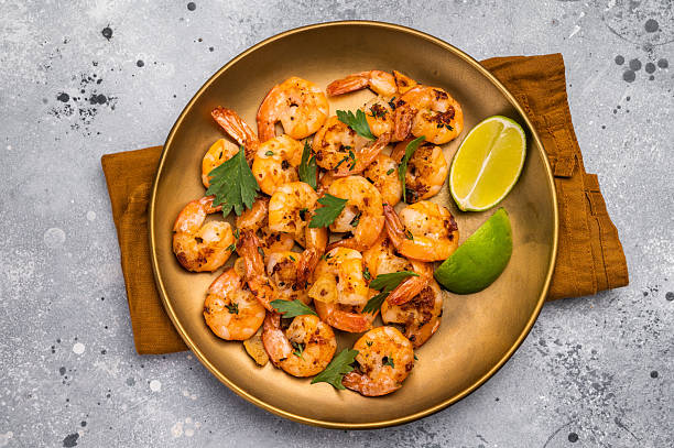 istock BBQ dinner with roast Shrimps Prawns in a plate. Gray background. Top view 2218660877