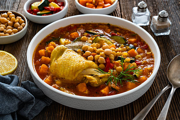 istock Fresh vegetable soup with lentil, chickpea and chicken on wooden table 2218661214