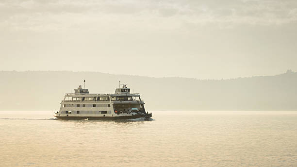 istock Ferry crossing a lake at sunset 2218662278
