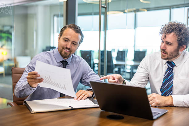 istock Businessmen collaborating at desk 2218665034