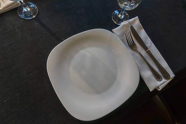 Elegant table setting for a gourmet dinner celebration with fine glassware and stylish cutlery in a modern restaurant ambiance