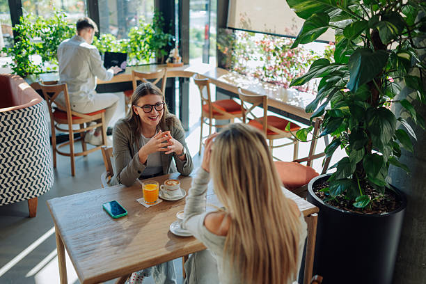 istock Two young women talking and drinking coffee in a cafe 2218668721