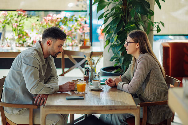 istock Young couple talking and drinking coffee in a cafe 2218668768