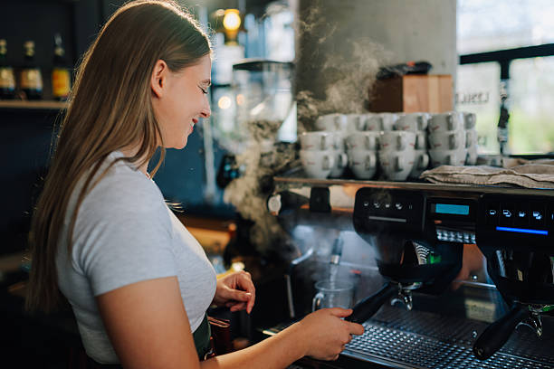 istock Young barista preparing coffee with professional machine 2218668934