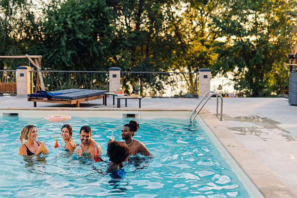 istock Friends enjoying drinks in swimming pool during summer vacation 2218669406