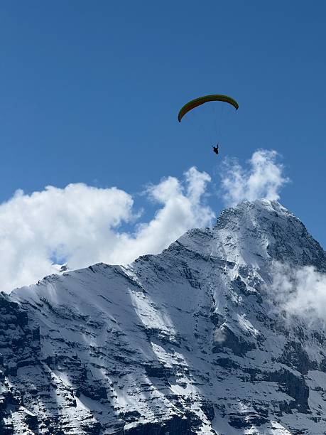 istock Paragliding Over Snowy Mountain Peaks Under a Vibrant Blue Sky 2218669965