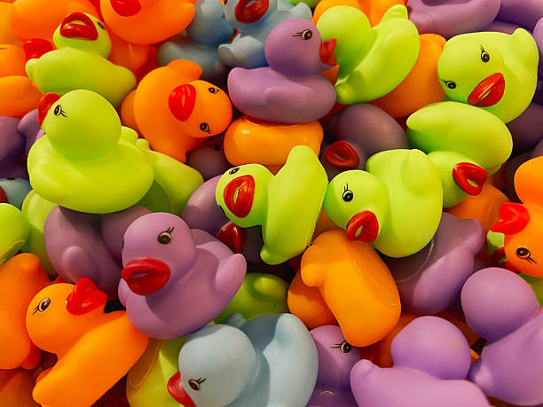 istock Bright Neon Rubber Ducks in Mixed Colors Forming a Playful Abstract Pattern 2218670006