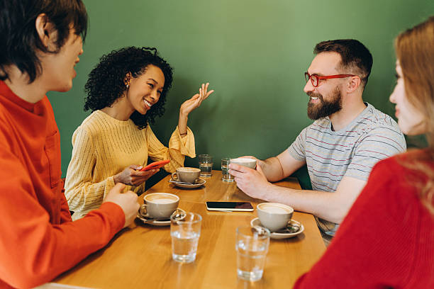 istock Diverse group of multinational friends enjoying coffee and conversation at cafe table 2218670161