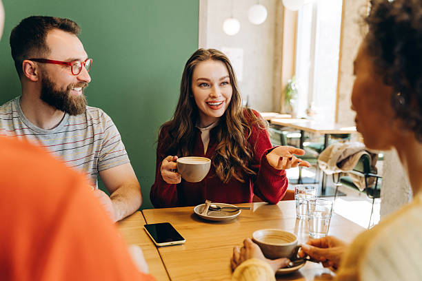 istock Friends enjoying a coffee break, talking and smiling in a cafe 2218670162