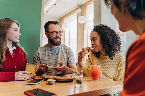 istock Friends eating pizza and drinking juice in restaurant 2218670185