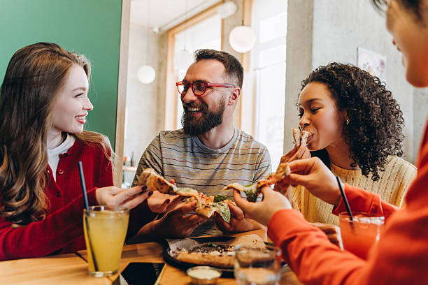 istock Friends eating pizza together in restaurant and having fun 2218670186