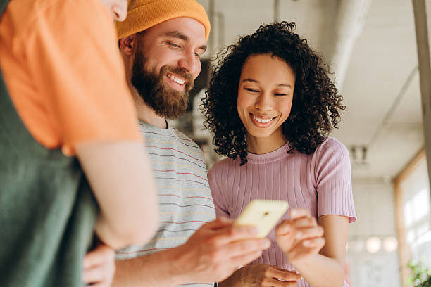 istock Creative team using phone and smiling during a meeting 2218670222