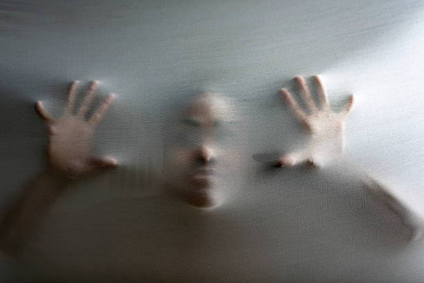 istock Person in spooky situation behind fabric representing mental illness 2218672237