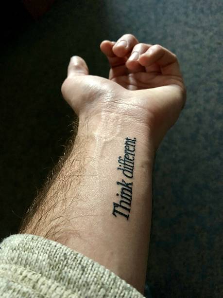 istock Hand With 'Think Different' Tattoo Focused in Intimate Lighting 2218673478