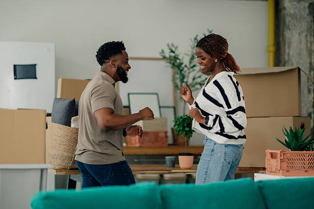 istock Happy couple dancing and celebrating moving into new home 2218674319