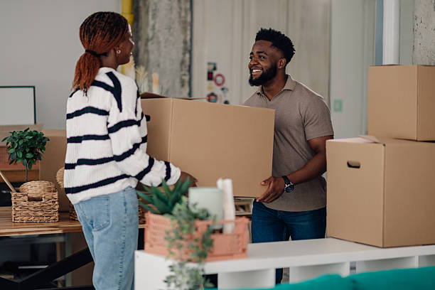 istock Young couple moving into new office space together 2218674365