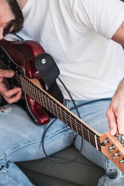 istock Musician tuning electric guitar before performing live 2218675259