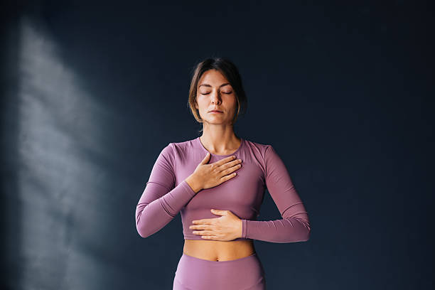 istock Woman Practicing Mindfulness with Hand on Chest and Stomach 2218675390