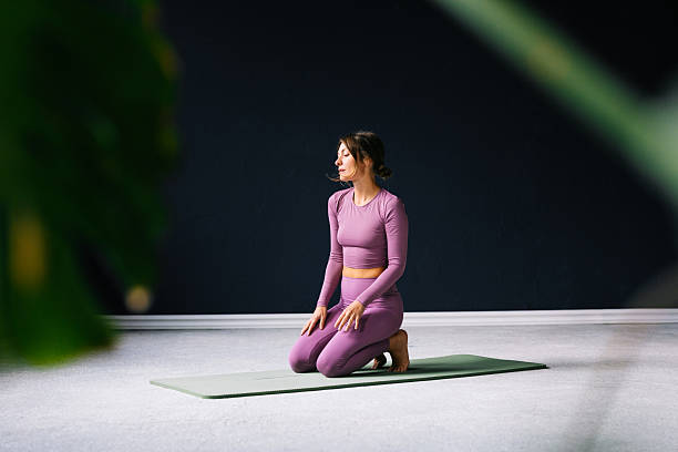 istock Woman Meditating on a Yoga Mat in a Minimal Studio Setting 2218675451
