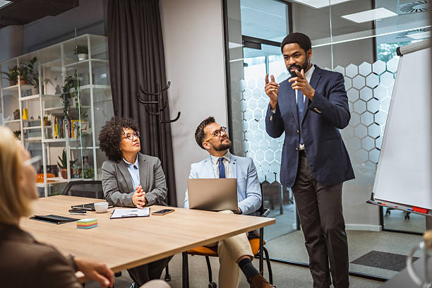 istock Man tutor present project on whiteboard to diverse colleagues 2218676576