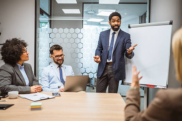 istock Man tutor present project on whiteboard to diverse colleagues 2218677244