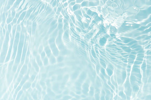 istock Blue water with ripples on the surface. Defocus blurred transparent blue colored clear calm water surface texture with splashes and bubbles. Water waves with shining pattern texture background. 2218680512