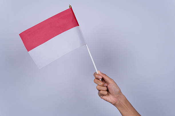 istock Hand Holding a Red and White Flag, Indonesian Independence Day Concept 2218682098