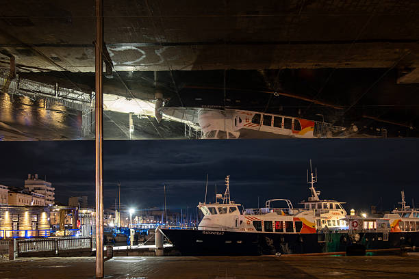 reflections of ship masts in calm blue water