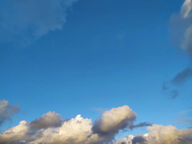 istock Vibrant blue sky with fluffy clouds. Serene, peaceful scene perfect for backgrounds, nature themes, or adding a touch of tranquility. Ideal for inspirational content. 2218683474