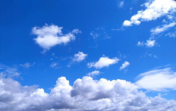 Vibrant blue sky filled with fluffy, white clouds. Represents freedom, peace, and opportunity. Perfect for backgrounds, nature themes, or metaphorical concepts. Inspiring view.