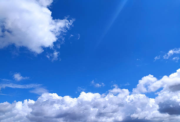 istock Vibrant blue sky filled with fluffy white clouds, suggesting freedom and tranquility. Ideal for backgrounds, travel themes, or representing optimism and open space. 2218683495