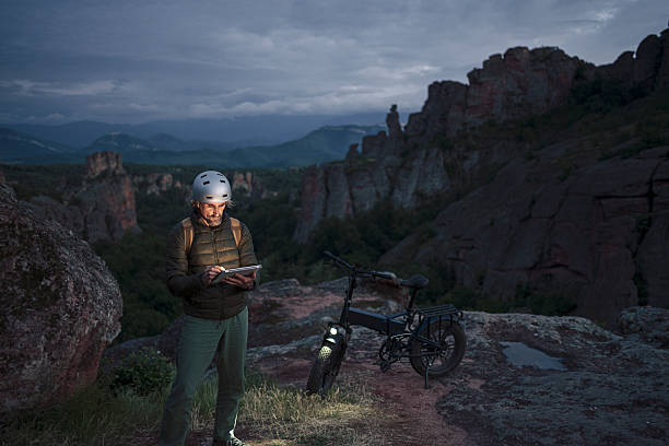 istock Solo Rider On E-Bike Illuminated By Digital Tablet At Dusk 2218683688