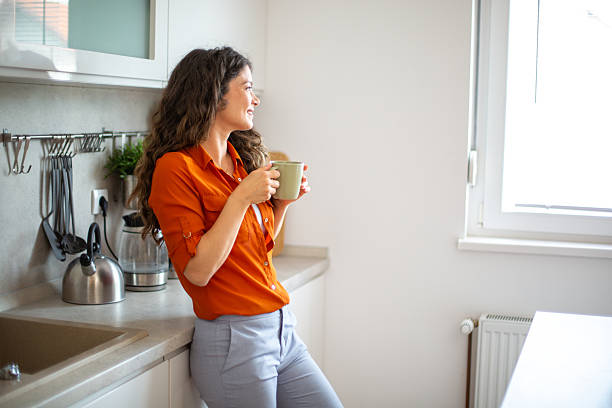 istock Woman enjoying a cup of coffee in her modern kitchen 2218684785