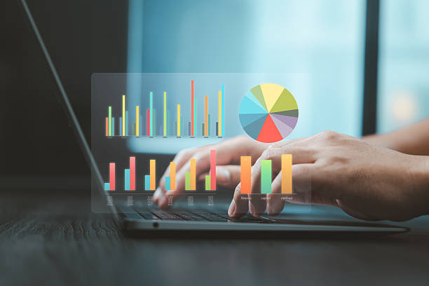istock Colorful chart graphs and pie diagram hovering over hands typing on laptop for business analytics 2218684838