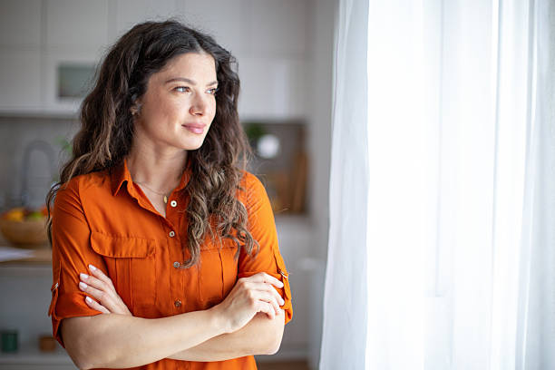 istock Serene woman looking out window, contemplating future 2218685761