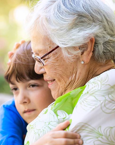 istock Smiling happy little boy hugging his grandmother 2218686517