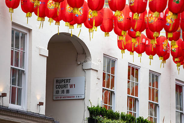 Red lanterns hang above Rupert Court in Londons Chinatown, adding vibrant color to the area.