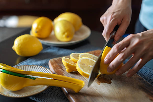 istock Slicing Fresh Lemons on Wooden Cutting Board 2218694605